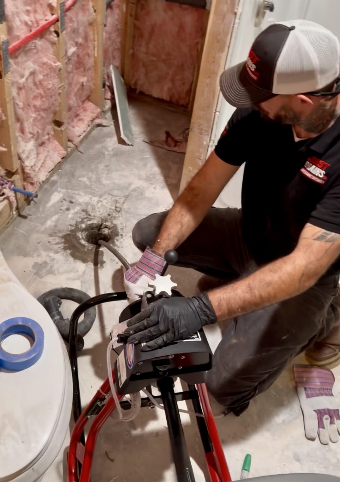 Just Drains technician working with a drain cleaning machine